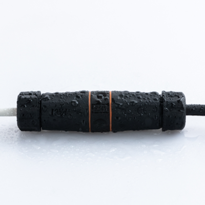 T3 waterproof inline connector with black textured surface and orange accents covered in water droplets